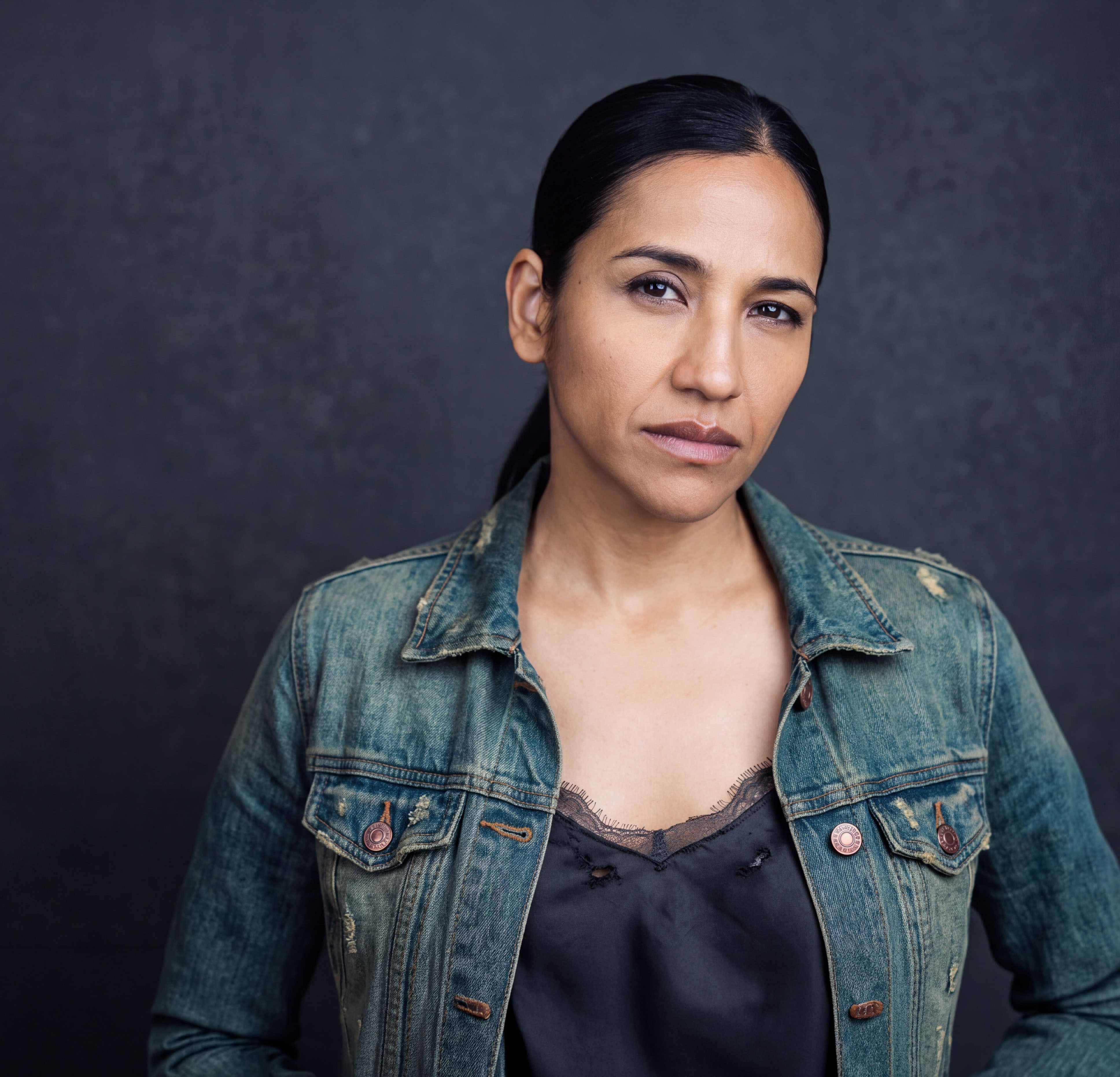 Headshot portrait of actress Priya Karki looking directly at the camera, featured in character for the play production.